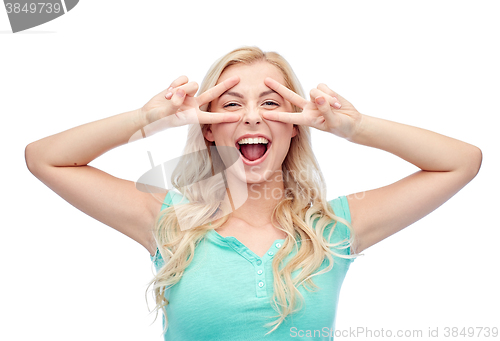 Image of smiling young woman or teenage girl showing peace