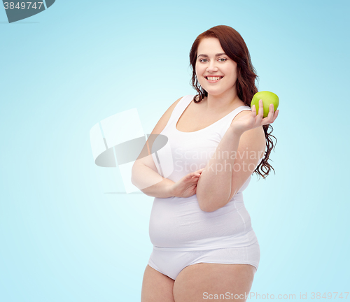 Image of happy plus size woman in underwear with apple
