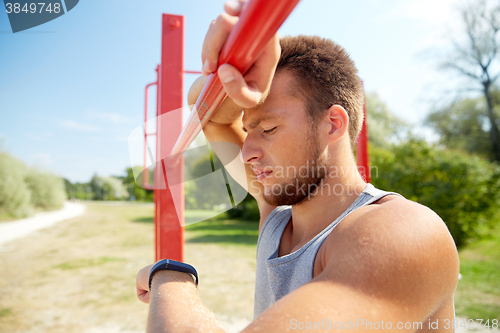 Image of man with heart-rate watch exercising outdoors