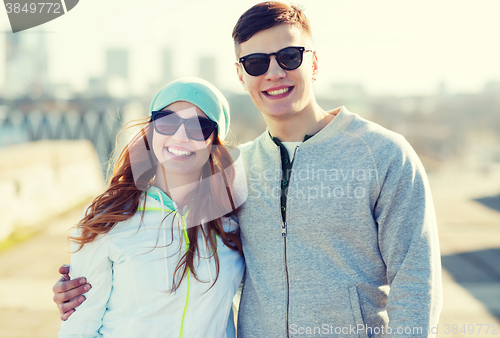 Image of happy teenage couple walking in city