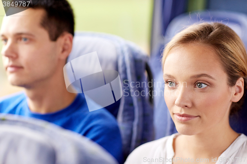 Image of happy young woman sitting in travel bus or train