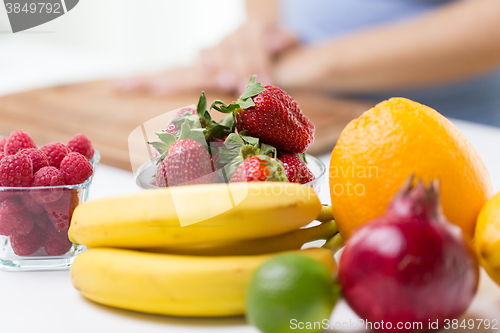 Image of close up of fresh fruits and berries on table