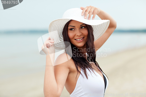 Image of happy young woman on beach