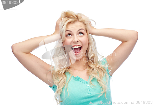 Image of smiling young woman holding to her head or hair