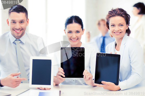 Image of business team showing tablet pcs in office