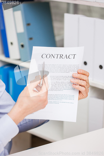 Image of close up of businessman holding contract document