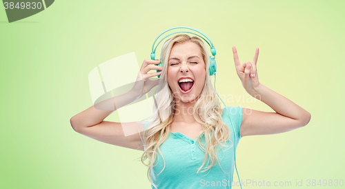 Image of happy young woman or teenage girl with headphones