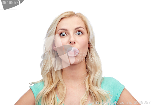 Image of happy young woman or teenage girl chewing gum
