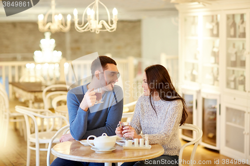 Image of happy couple drinking tea at cafe