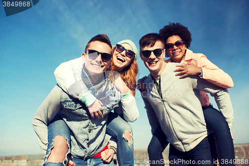 Image of happy friends in shades having fun outdoors