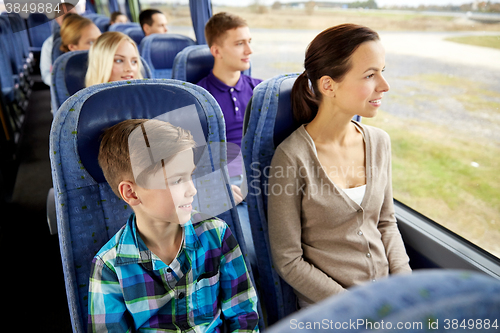 Image of happy family riding in travel bus