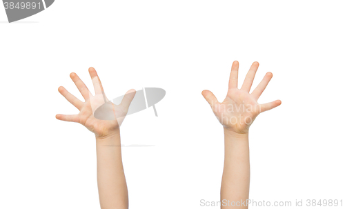 Image of close up of little child hands raised upwards