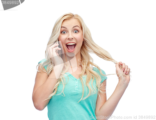 Image of smiling young woman calling on smartphone