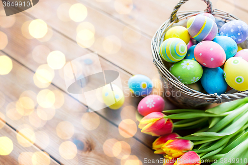 Image of close up of easter eggs in basket and flowers