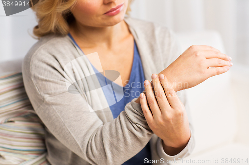 Image of close up of woman with pain in hand at home