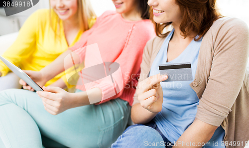 Image of teenage girls with tablet pc and credit card