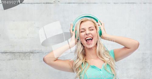 Image of happy young woman or teenage girl with headphones