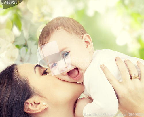 Image of happy laughing baby playing with mother