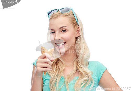 Image of happy young woman in sunglasses eating ice cream