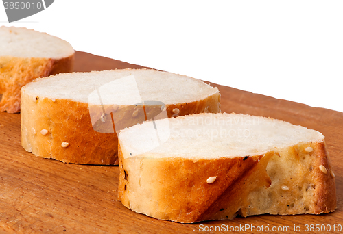 Image of Delicious fresh bread sliced on a wooden board