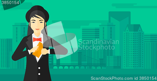 Image of Woman putting envelope in pocket.