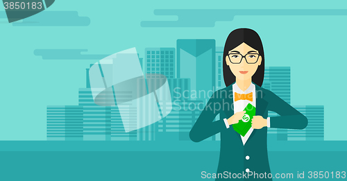 Image of Woman putting money in pocket.