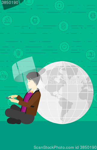 Image of Man sitting near globe.