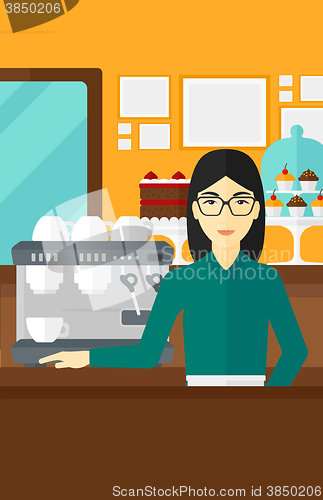 Image of Barista standing near coffee maker.