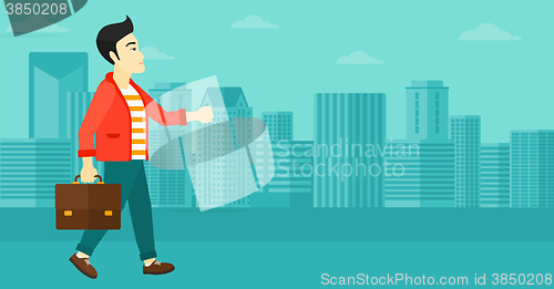 Image of Businessman walking with briefcase. 