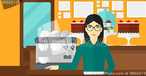 Image of Barista standing near coffee maker.