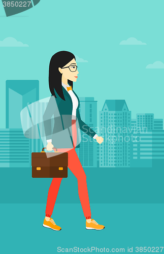 Image of Business woman walking with briefcase. 