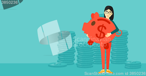 Image of Woman carrying piggy bank.