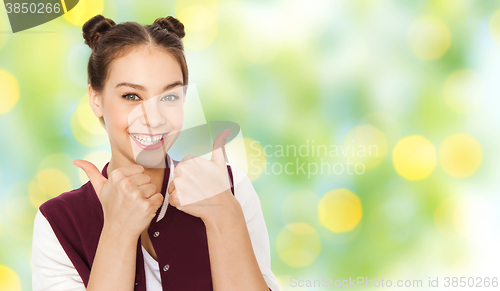 Image of happy teenage girl showing thumbs up