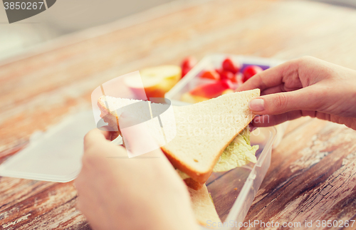 Image of close up of woman with food in plastic container