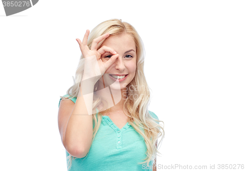 Image of young woman making ok hand gesture