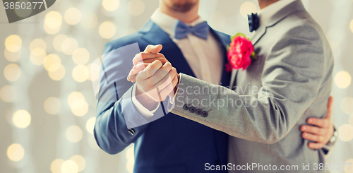 Image of close up of happy male gay couple dancing