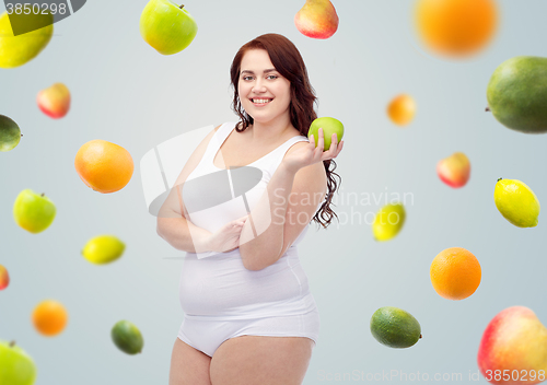 Image of happy plus size woman in underwear with apple