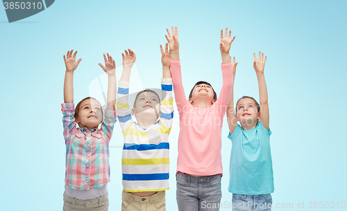 Image of happy children celebrating victory over blue