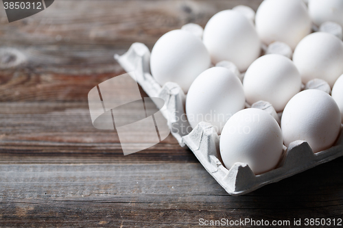 Image of White chicken eggs on old wooden table