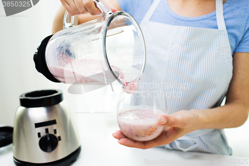 Image of close up of woman with blender and shake at home