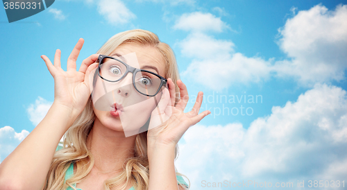 Image of happy young woman in glasses making fish face