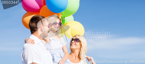 Image of family with colorful balloons