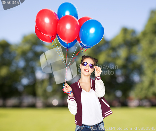 Image of happy teenage girl with helium balloons