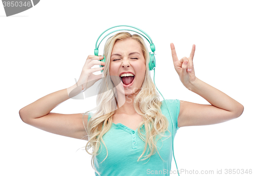 Image of happy young woman or teenage girl with headphones