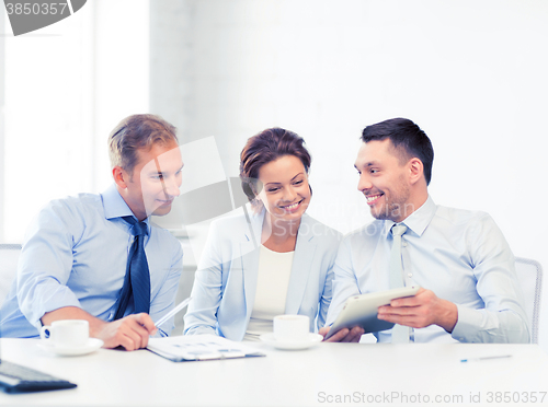 Image of business team having fun with tablet pc in office