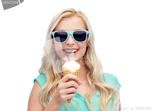 Image of happy young woman in sunglasses eating ice cream