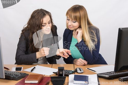 Image of Young girl in the office break enthusiastically discussing lipstick at your desk