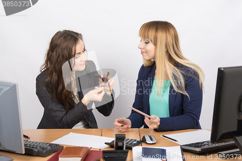 Image of Office employee in a break to discuss cosmetic products at your desk