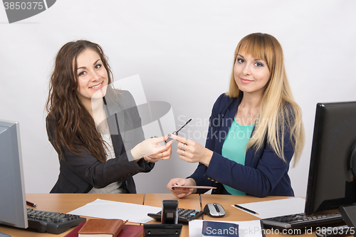 Image of two Office workers suggest make-up desk