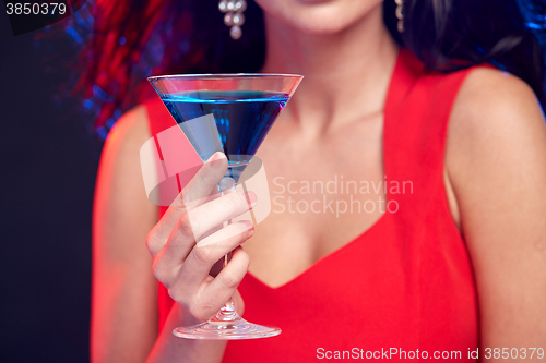 Image of close up of woman with cocktail at nightclub